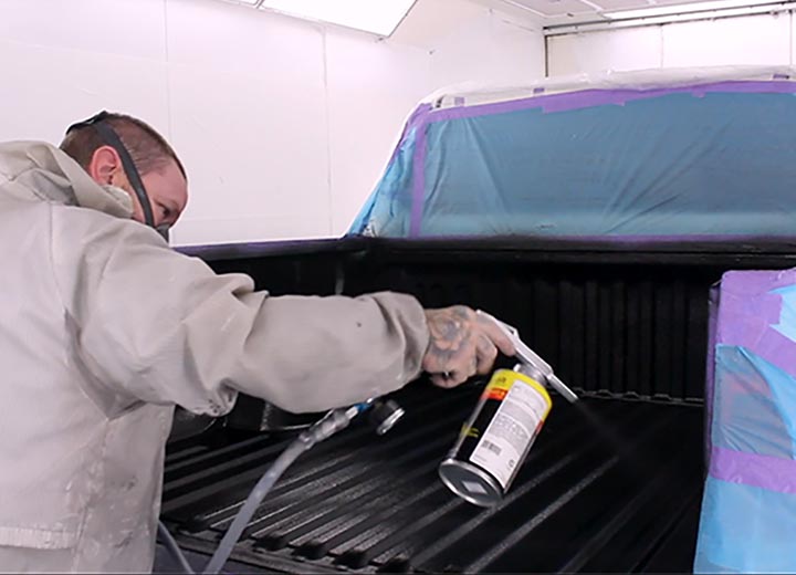 Col Wilkie Body Works team member spraying ute with Dominator Spray Liner