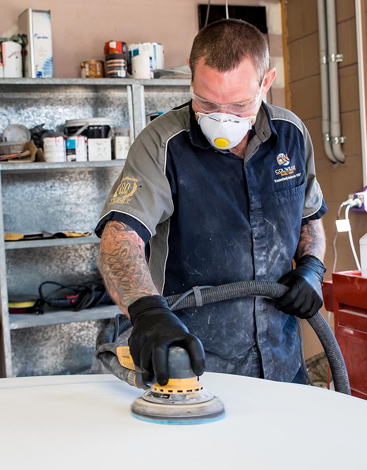 Col Wilkie Body Works team member polishing vehicle